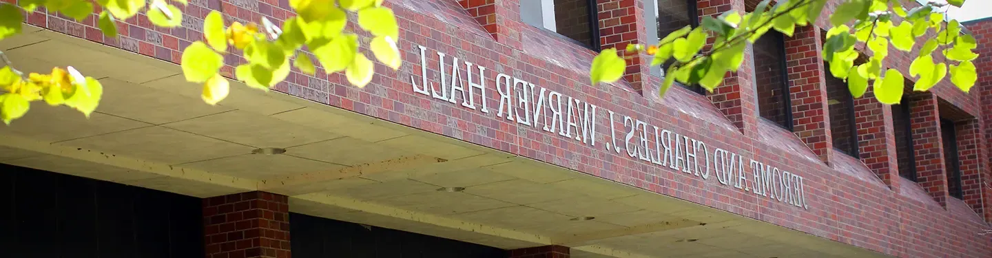 a picture of Warner hall. Sign reads: Jerome and Charles J Warner Hall